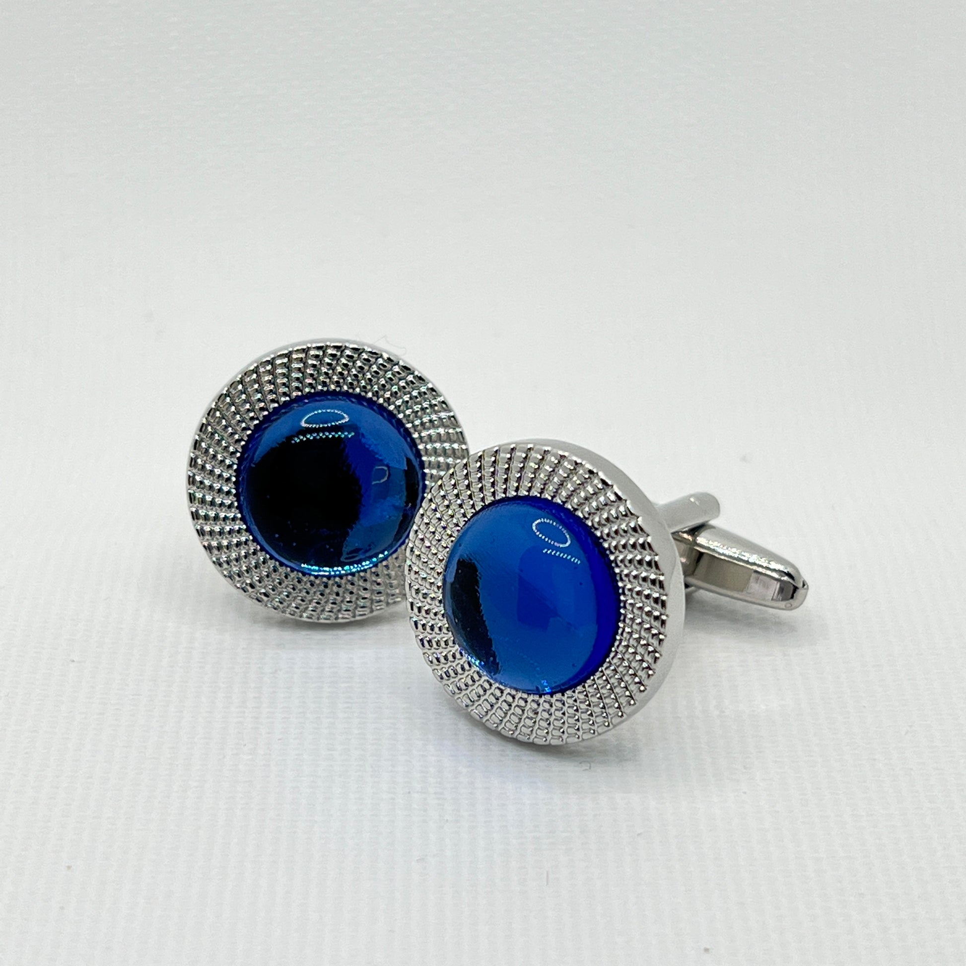 Round machined cufflinks with striking clear blue crystal
